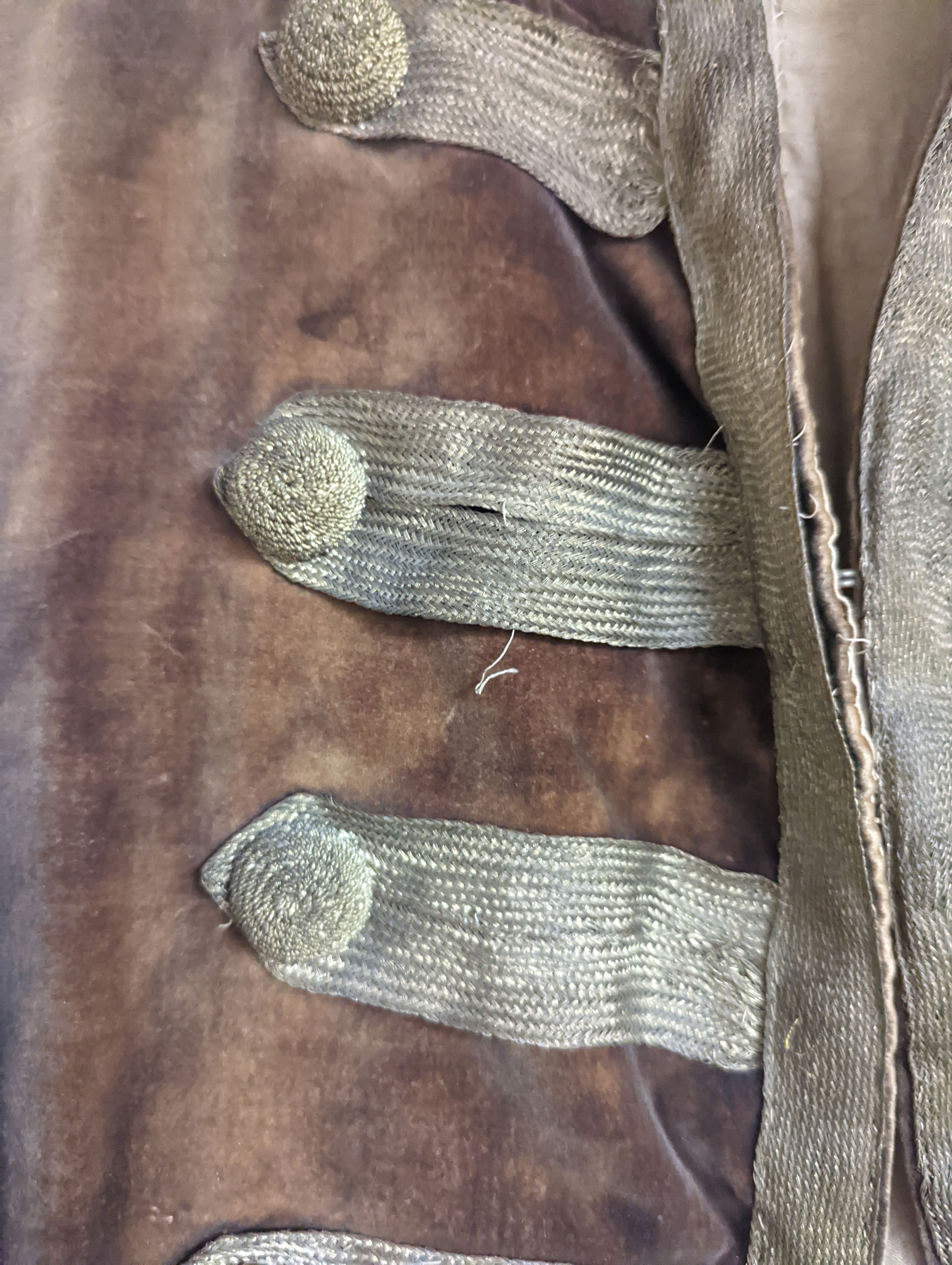A Georgian gents cream damask waistcoat, a similar waistcoat with beading applied later and a velvet and gold braided tailcoat